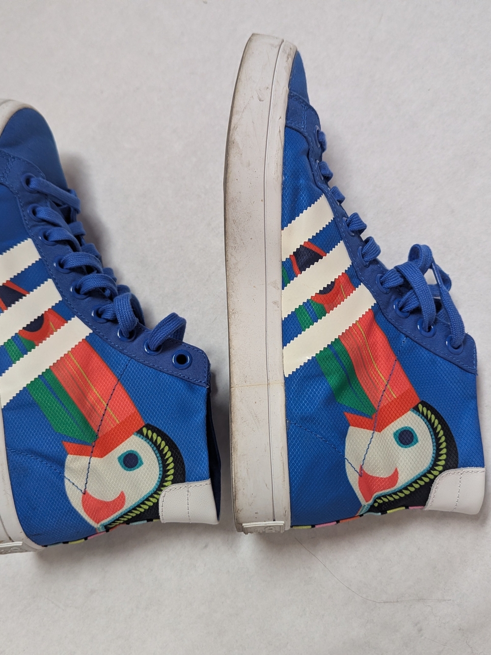 adidas Originals Blue High-Top Sneakers with Colorful Parrot Graphic